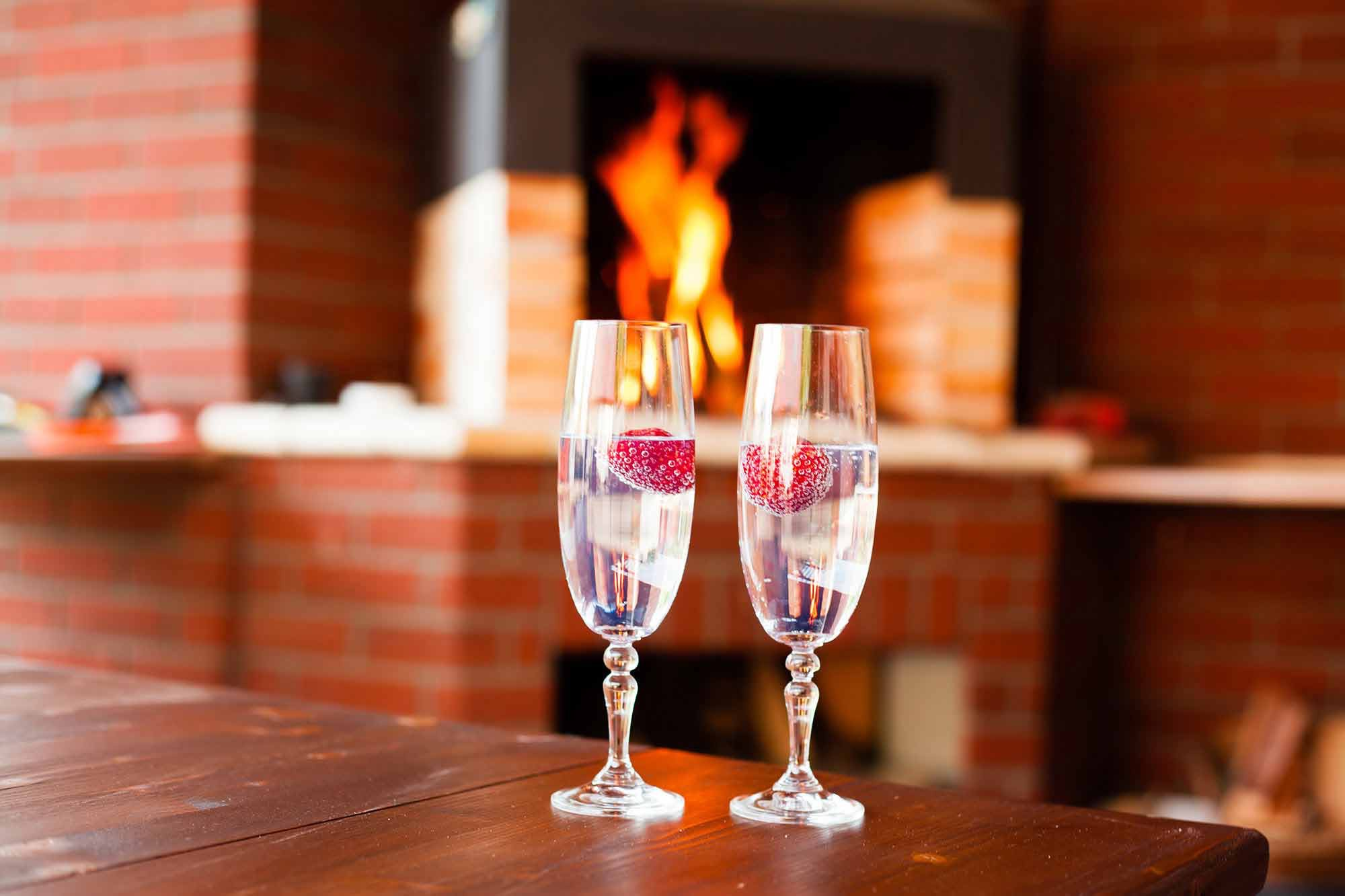 sparkling wine in front of outdoor fireplace