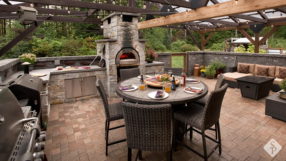 pizza oven in outdoor kitchen on paver patio