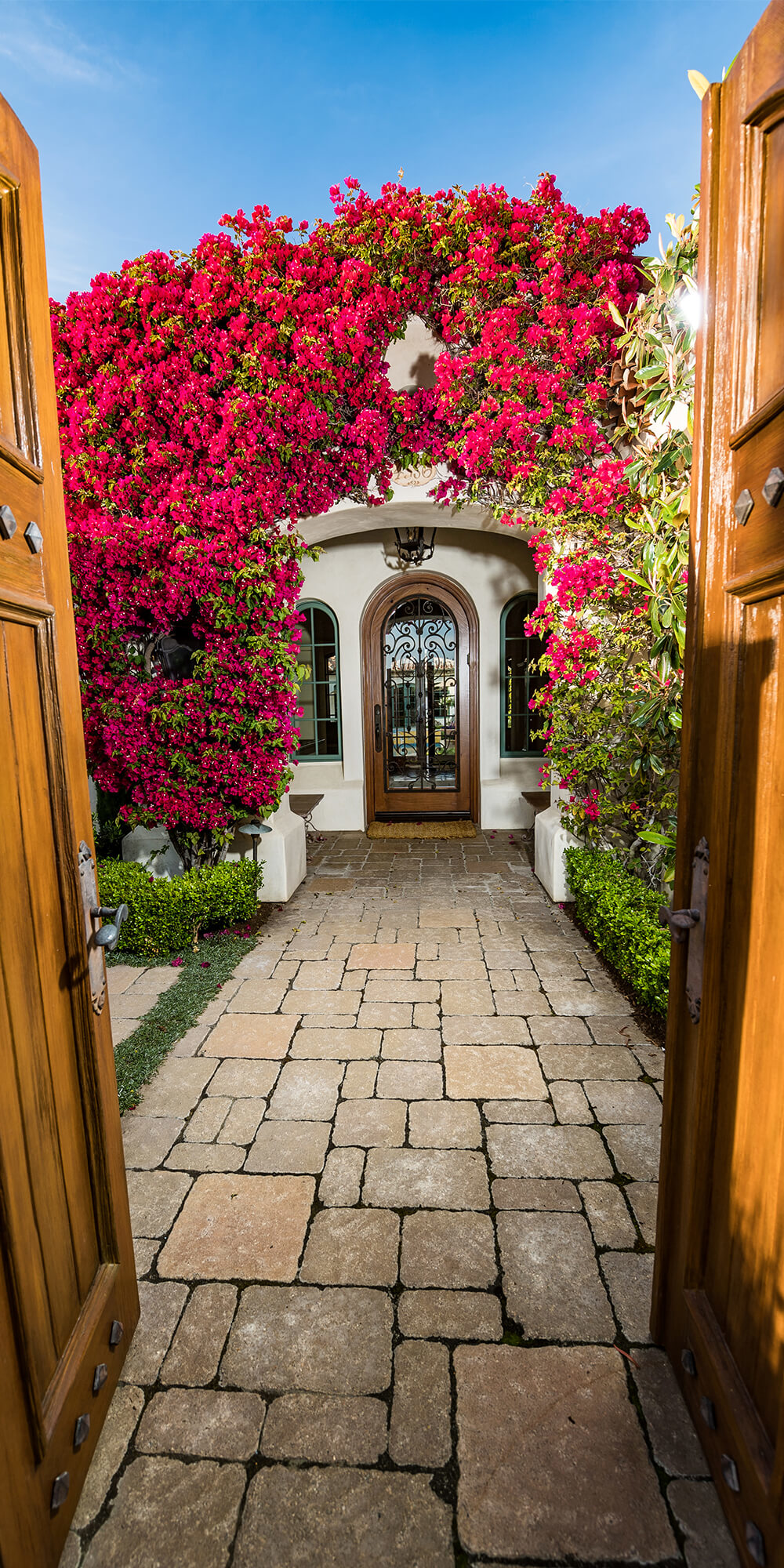 Pavers and lighted steps leading up to door with window lighting