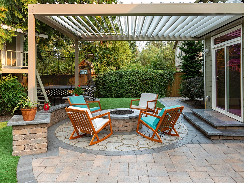 Backyard paver patio with built-in fire pit and pergola. 