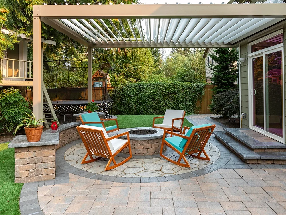 Backyard paver patio with built-in fire pit and pergola. 