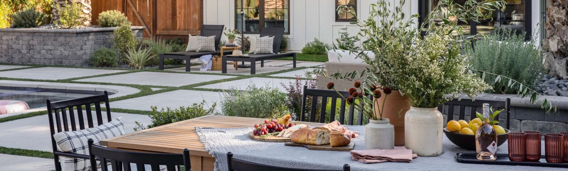 Backyard outdoor transformation with paver and turf lawn and dining area