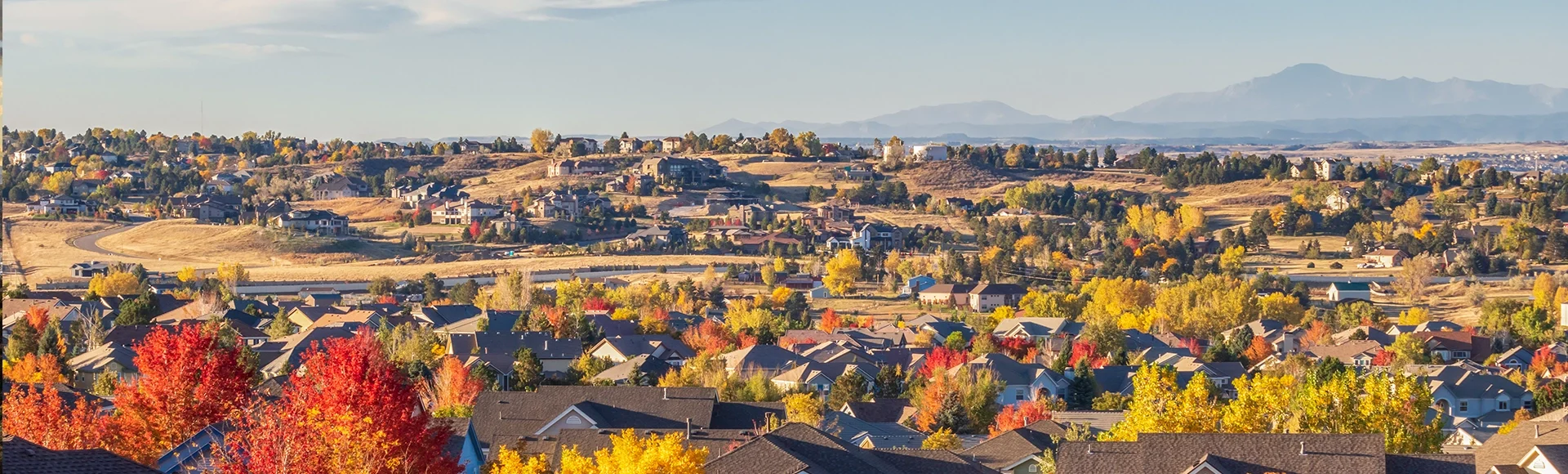 Colorado Living. Centennial, Colorado - Denver Metro Area Residential Autumn Panorama with the view of a Front Range mountains in the distance