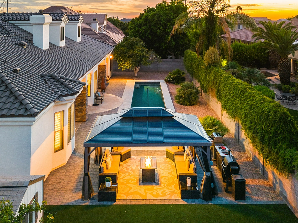 Beautiful backyard in Arizona with pergola, artificial turf, and paver patio. 