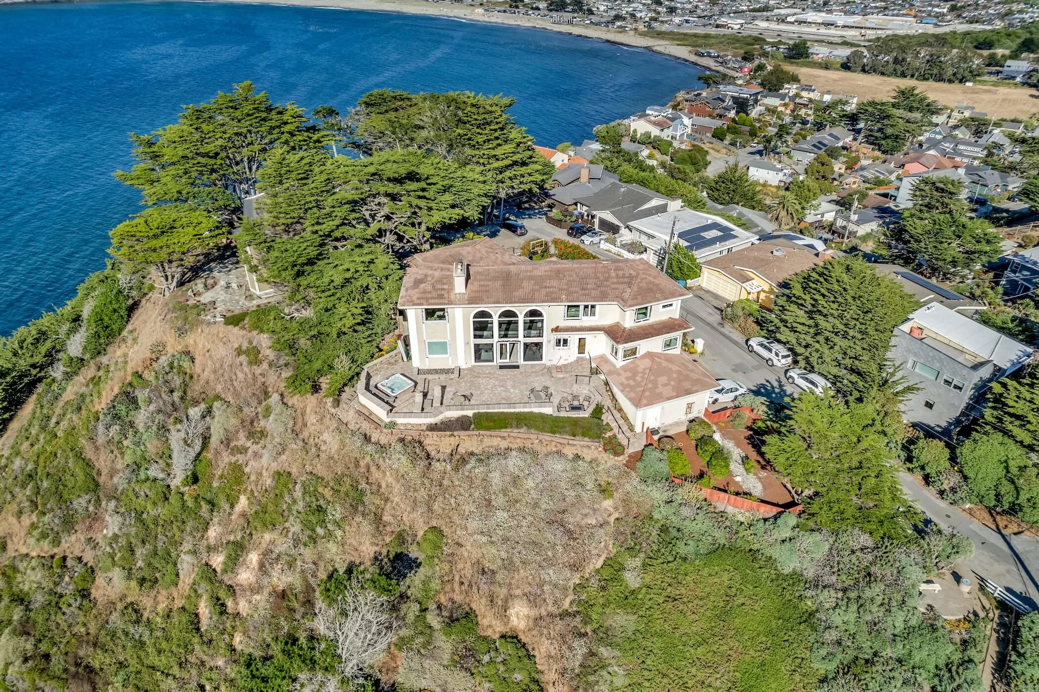Arial Overview of Coastal California Home with Paver Courtyard, Fire Pit, Hot Tub, and Paving Stone Stairs 