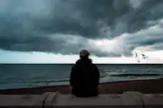 Depressed person at the beach
