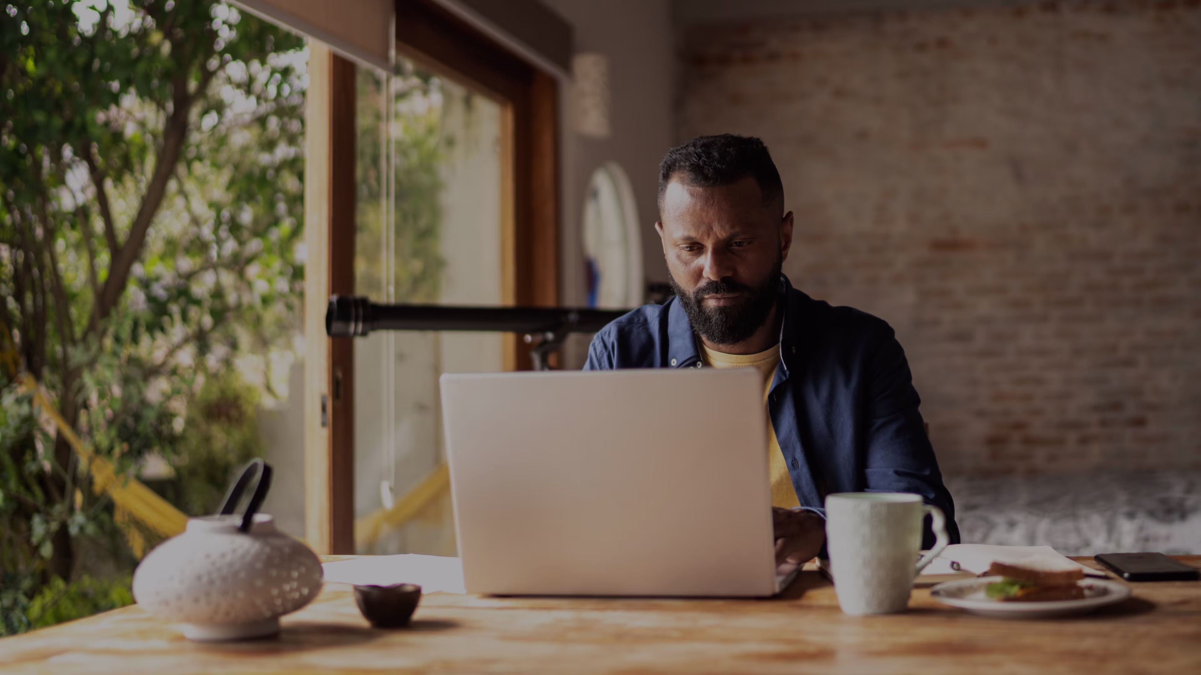 Man using laptop working at home (home office)