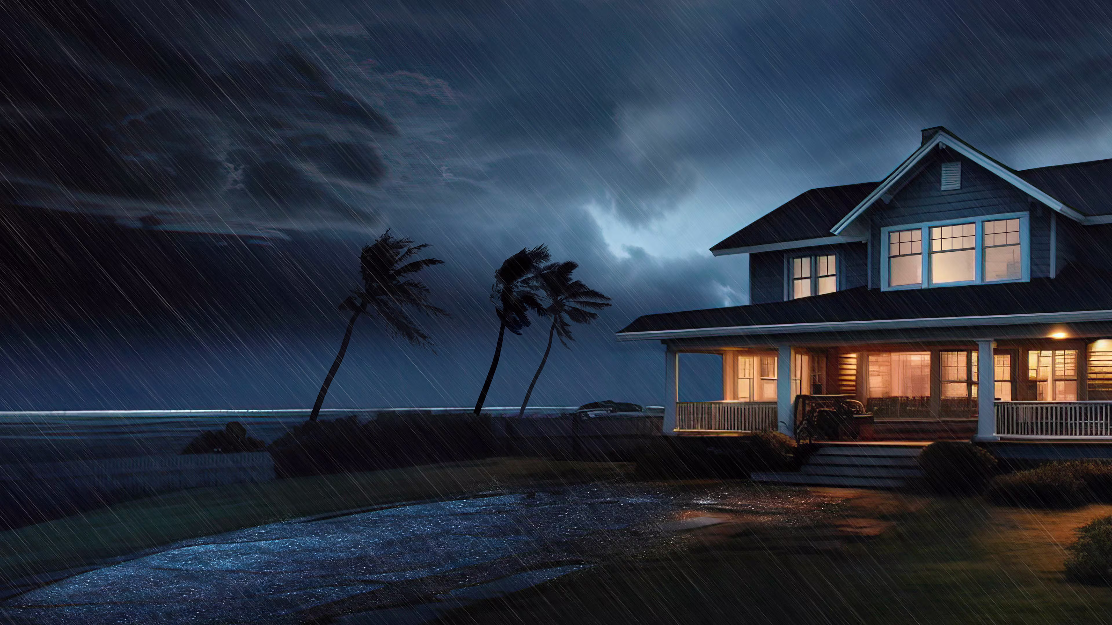 House by the beach with strong stormy weather with wind and rain, possibly hurricane.