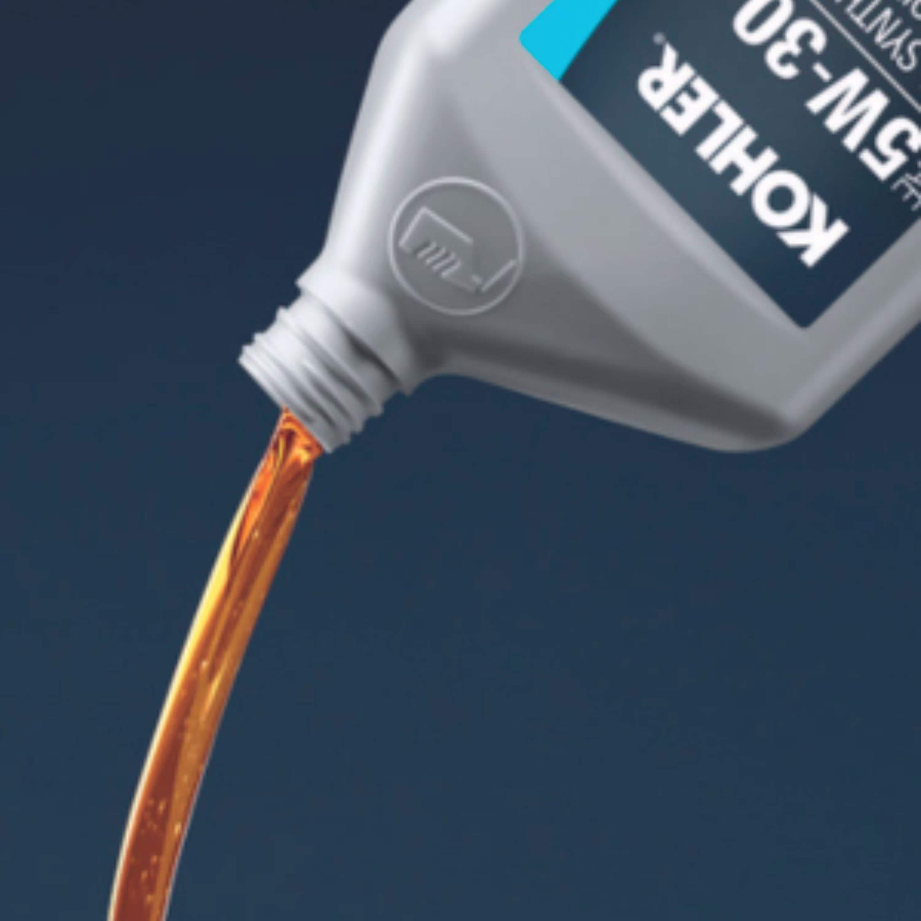 Bottle of KOHLER oil being poured.