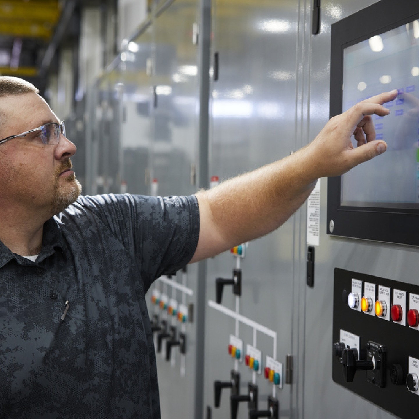 Man operating a touch display Rehlko controller.