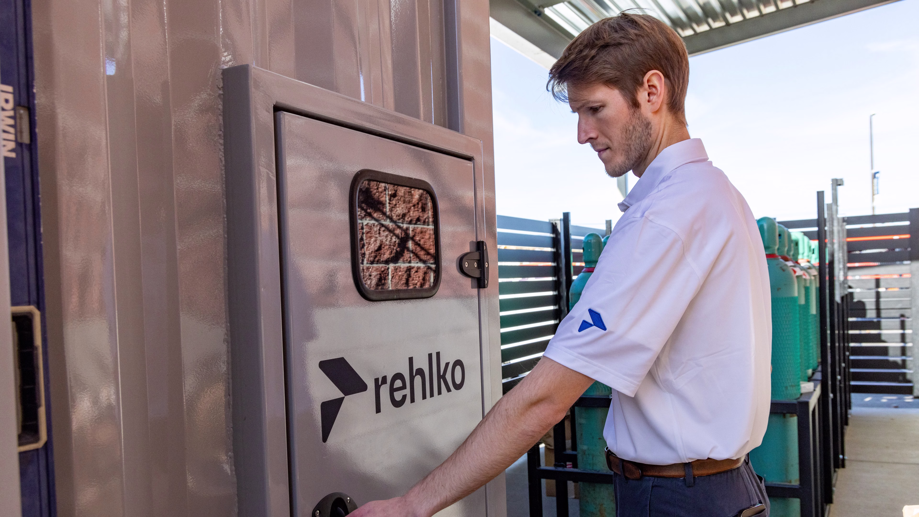 Rehlko employee in front of a panel door