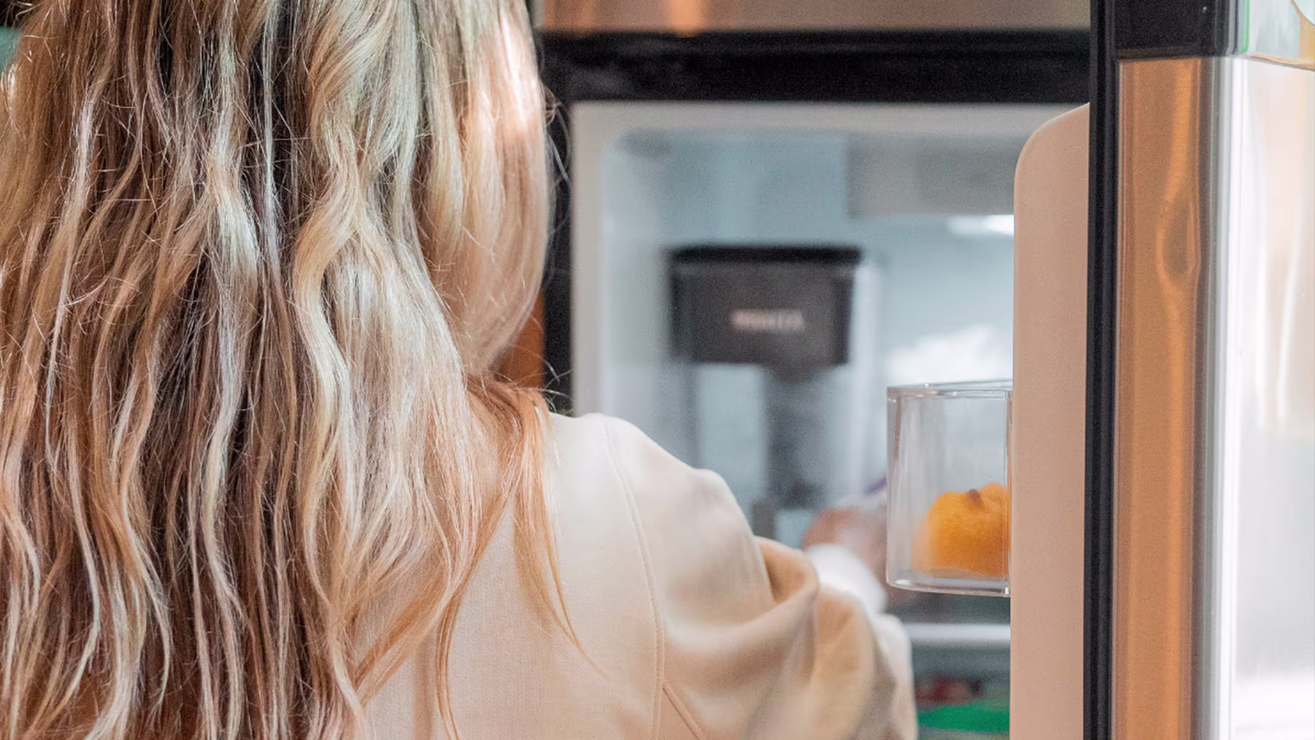 Woman in front of a open fridge