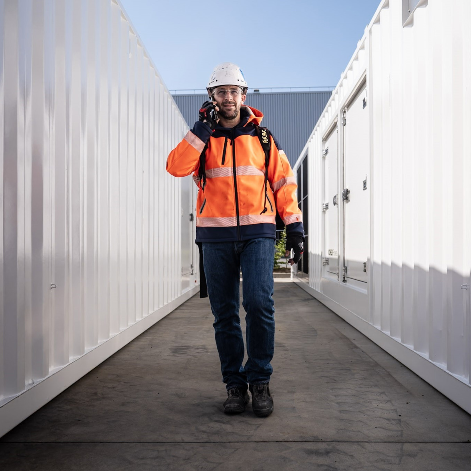 Worker walking between generators talking on a cellphone
Filename: datacenter-man-telephone.jpg