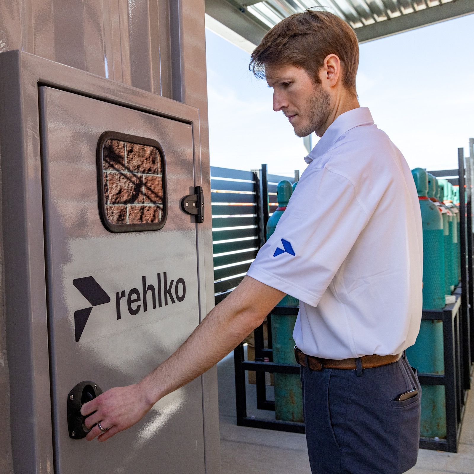 Klickitat Valley Health Toyota Hydrogen Fuel Cell Systems Rehlko employee in front of a panel door