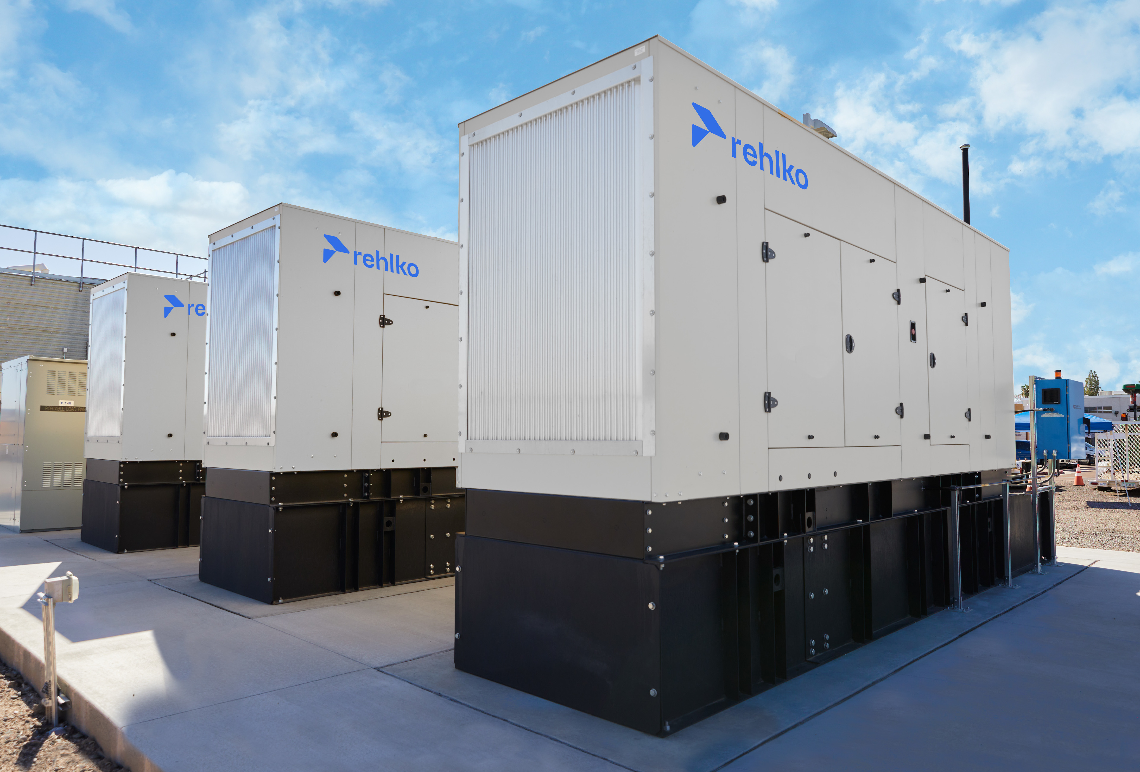 Three large enclosures installed on black floor bases / tanks
