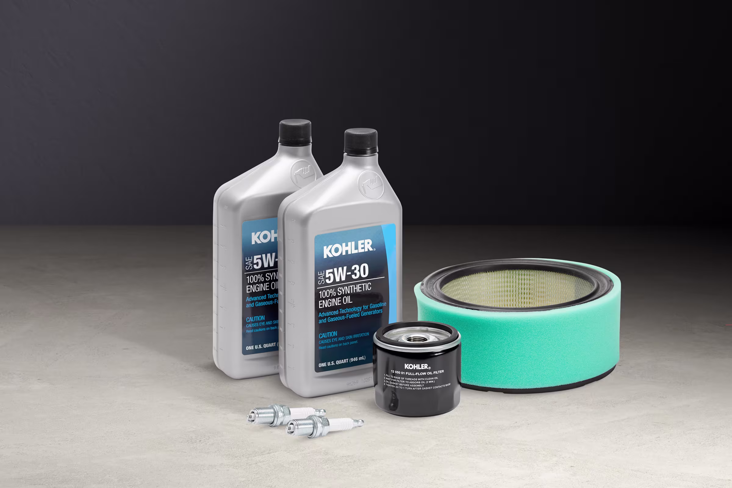 Generator maintenance items, including oil, an oil filter, an air filter, and spark plugs on a flat surface.