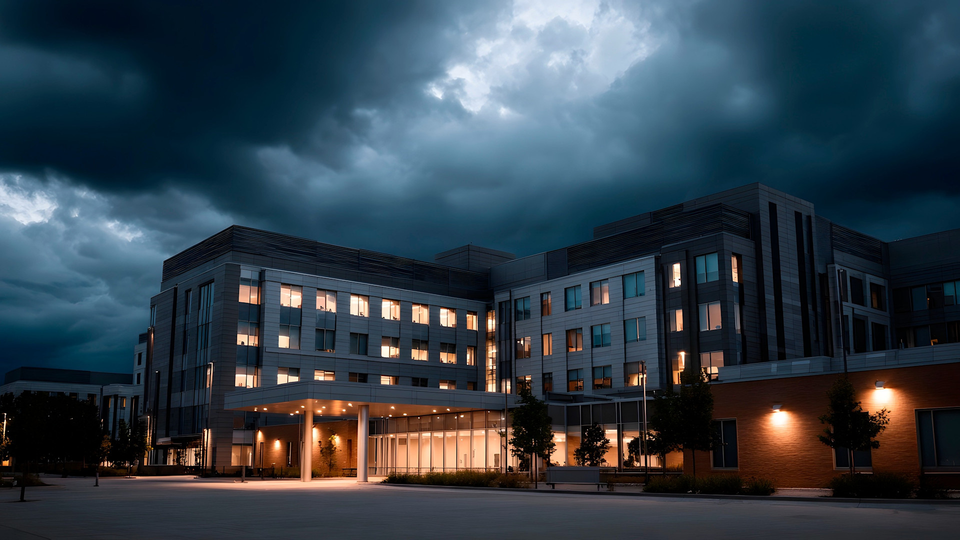 Grey building with lights on cloudy day