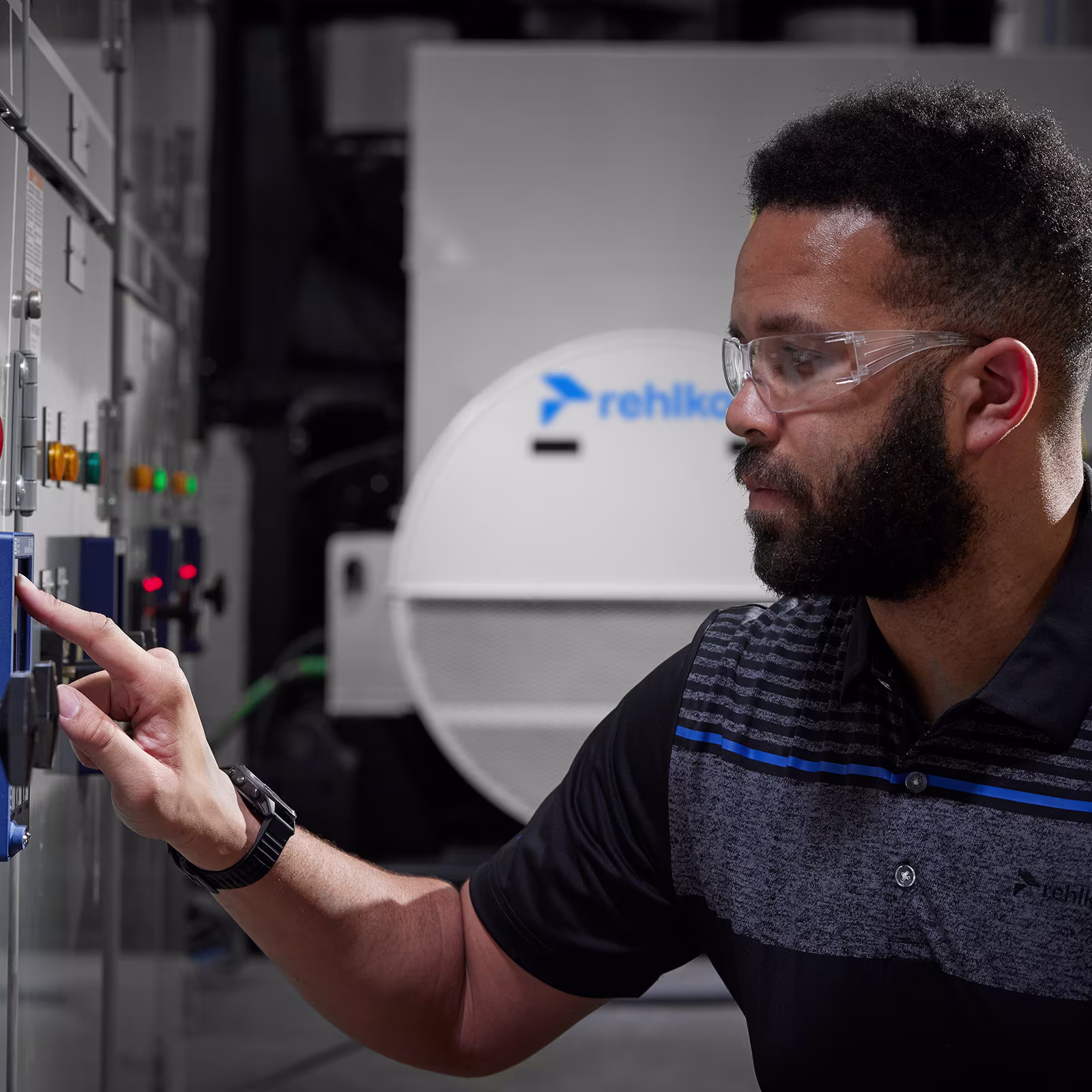 Man wearing Rehlko shirt working at a datacenter
