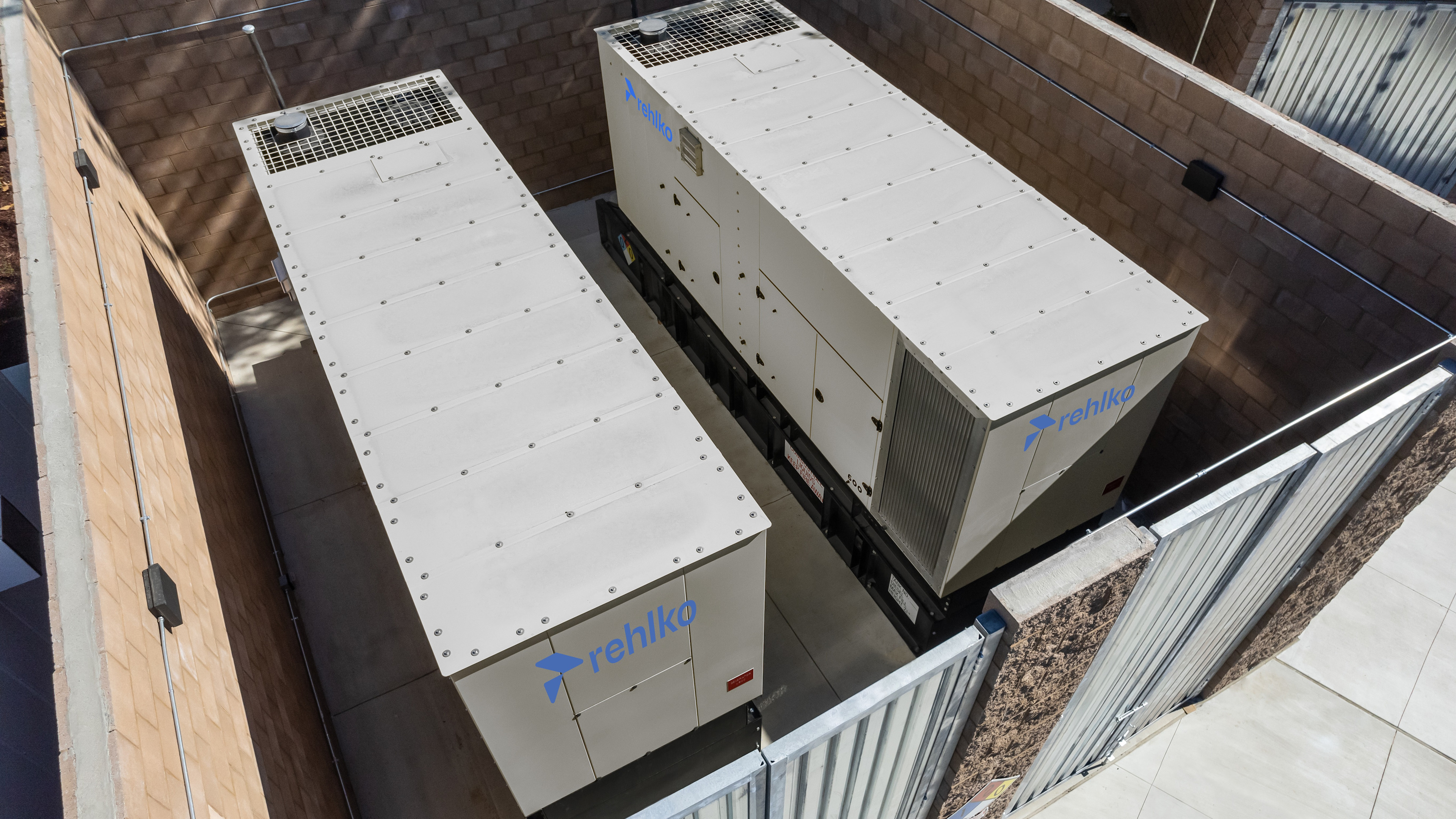 Aerial view of Rehlko enclosures inside a fenced area.