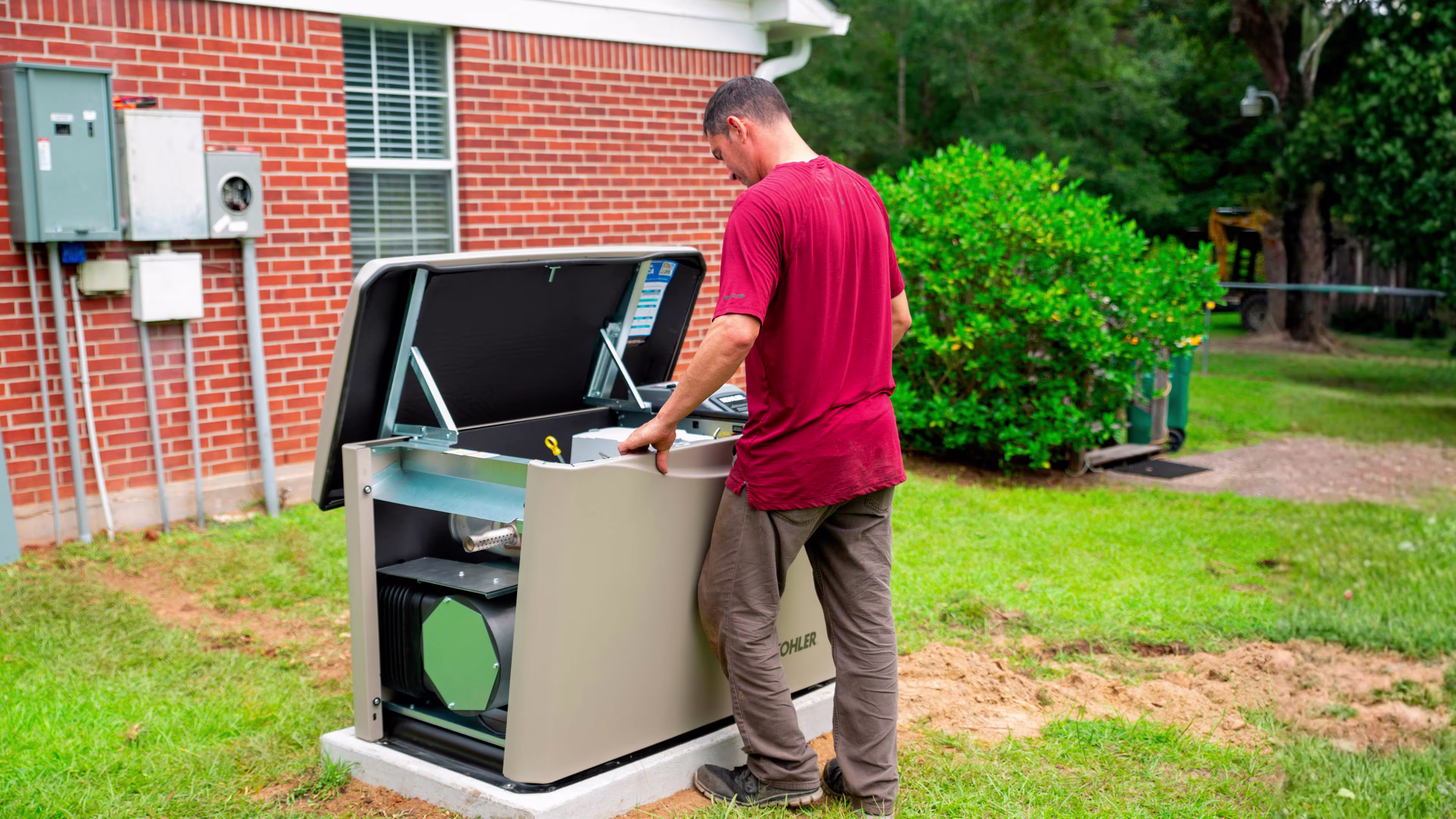Man in front of an open generator