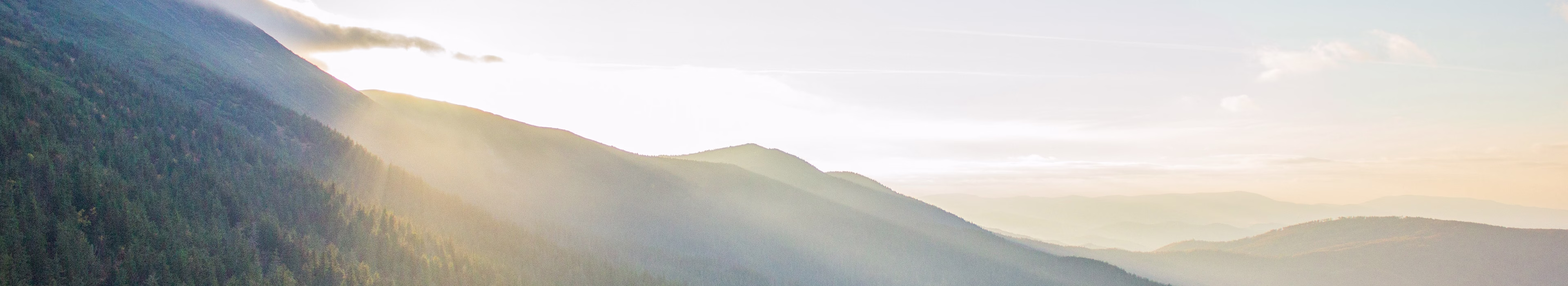 Mountain landscape representing lower-emissions power technologies and sustainable energy innovation.