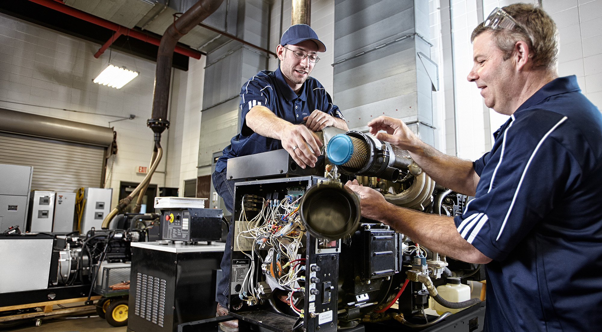 Two dealers working on a generator filter