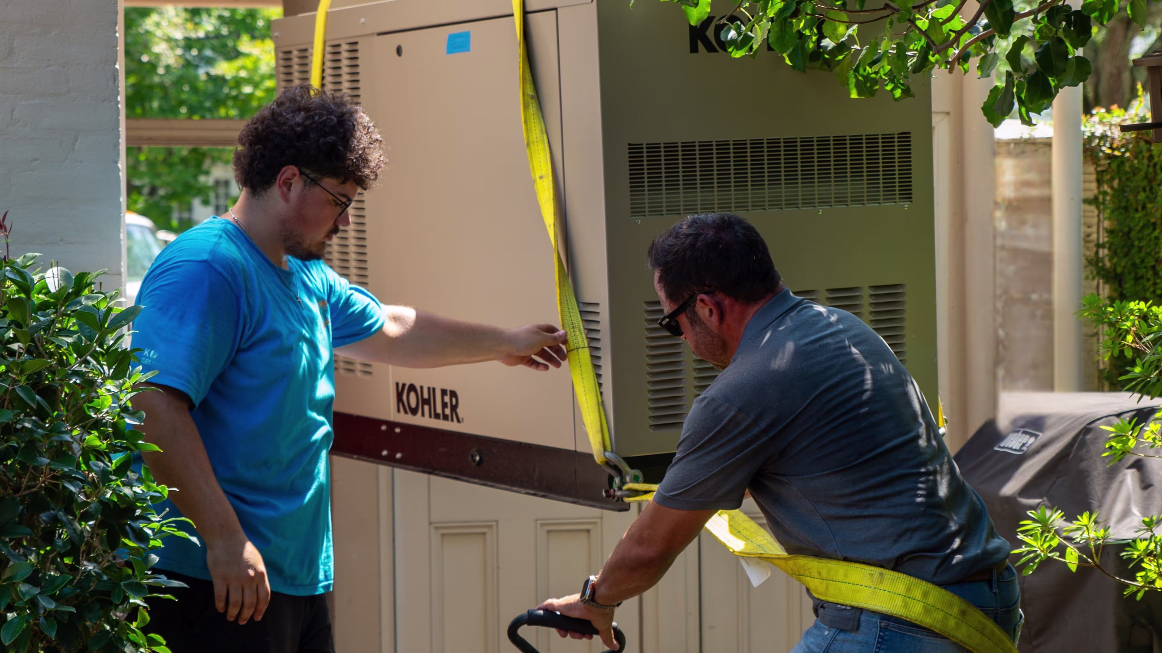 Two technicians servicing a home generator.