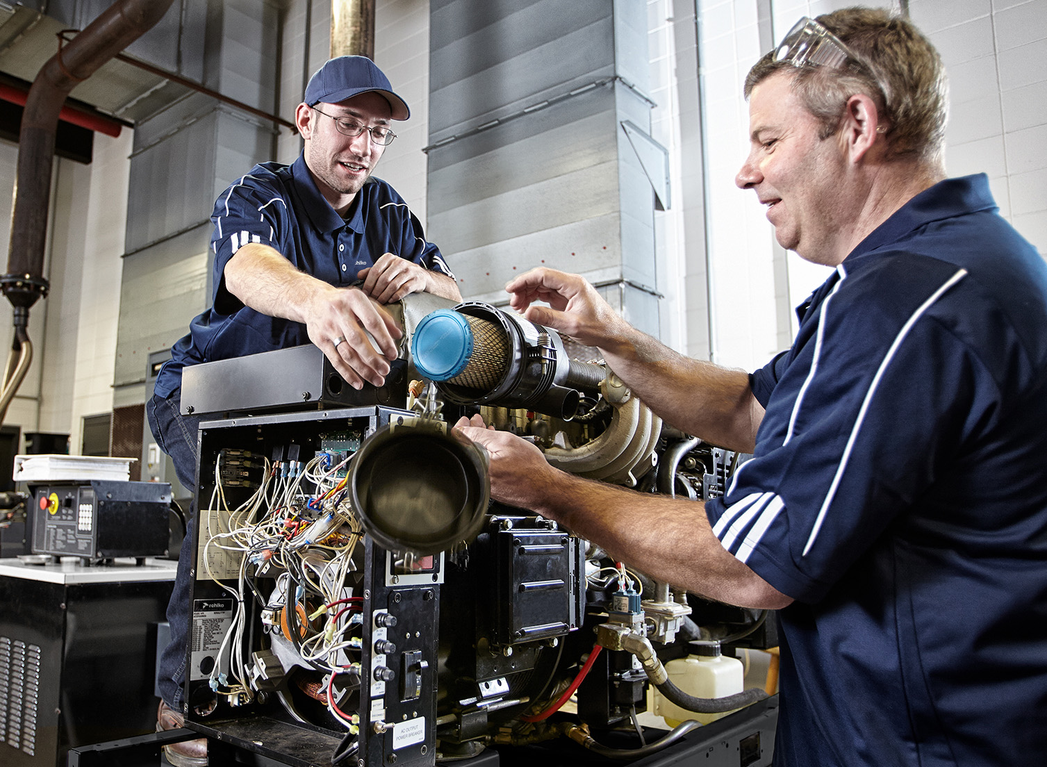 Two dealers working on a generator filter