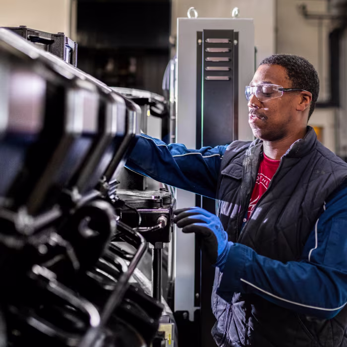 Man performing maintenance on an industrial equipment.