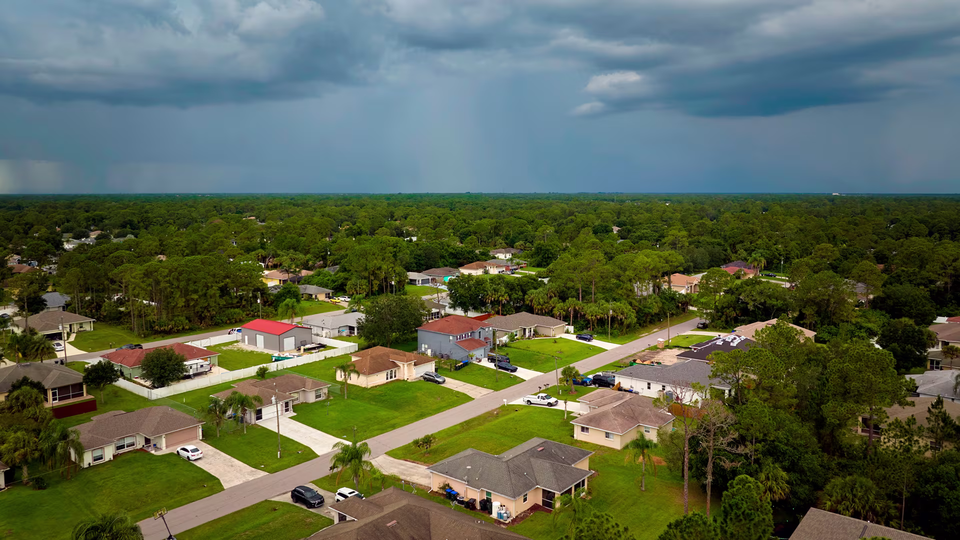 Aerial shot of multiple houses with a stormy sky
