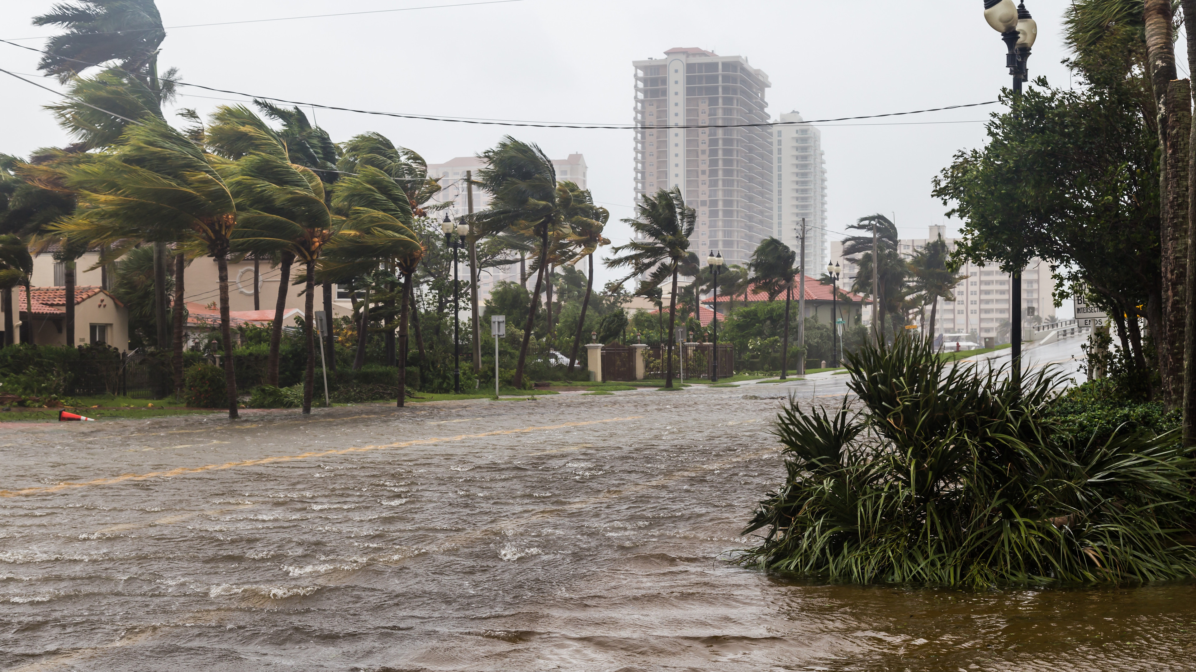 Hurricane storm clouds over the ocean near a city shoreline.