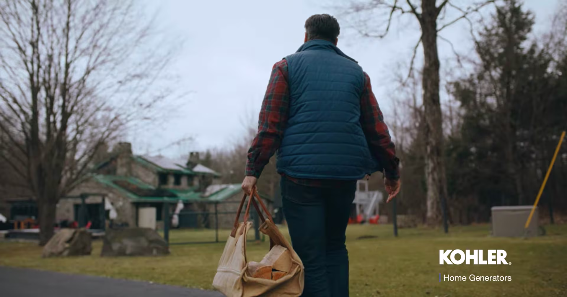 Image of Anthony Carrino walking in a sidewalk holding a beige bag.