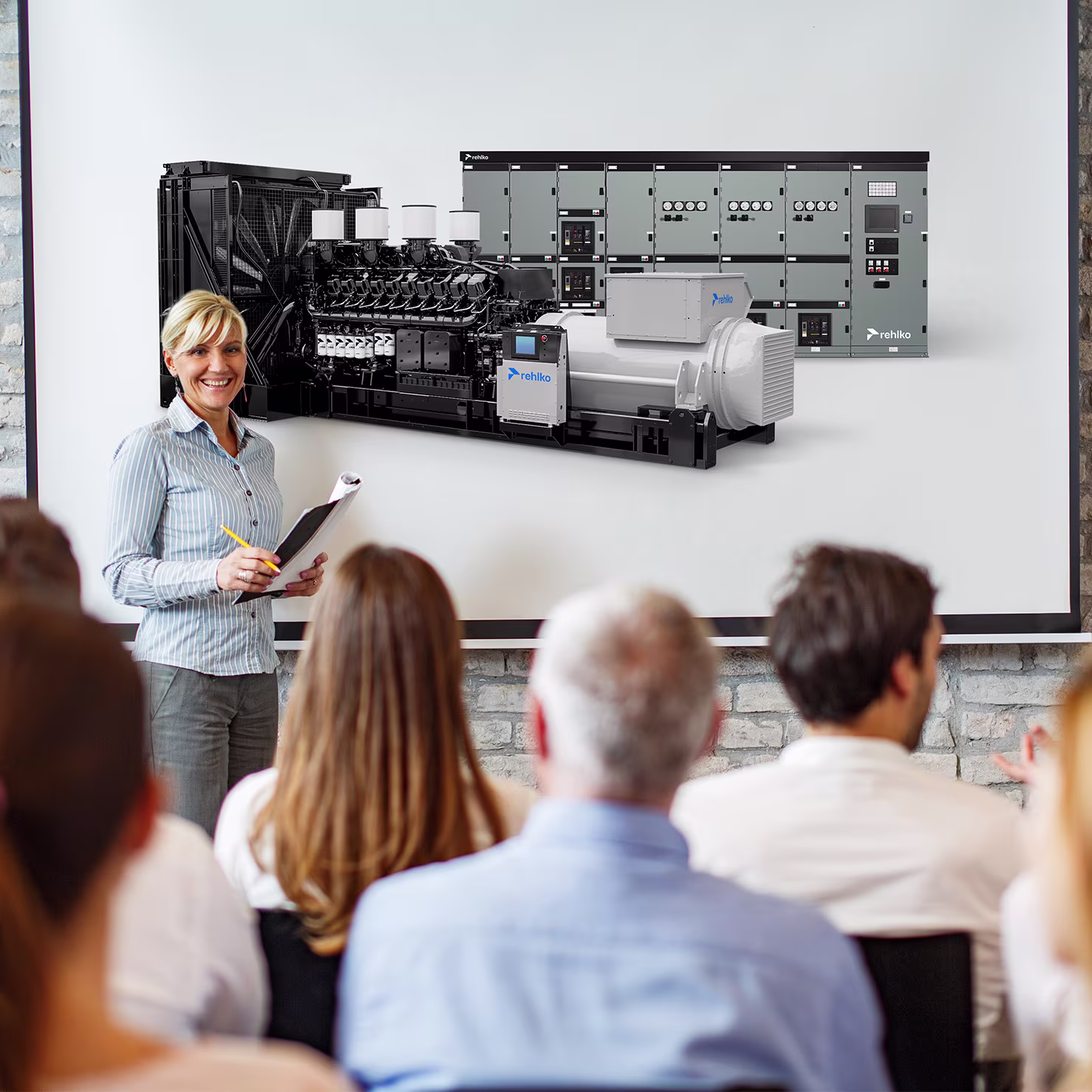 Women in front of room interacting with audience with Rehlko products showing on screen