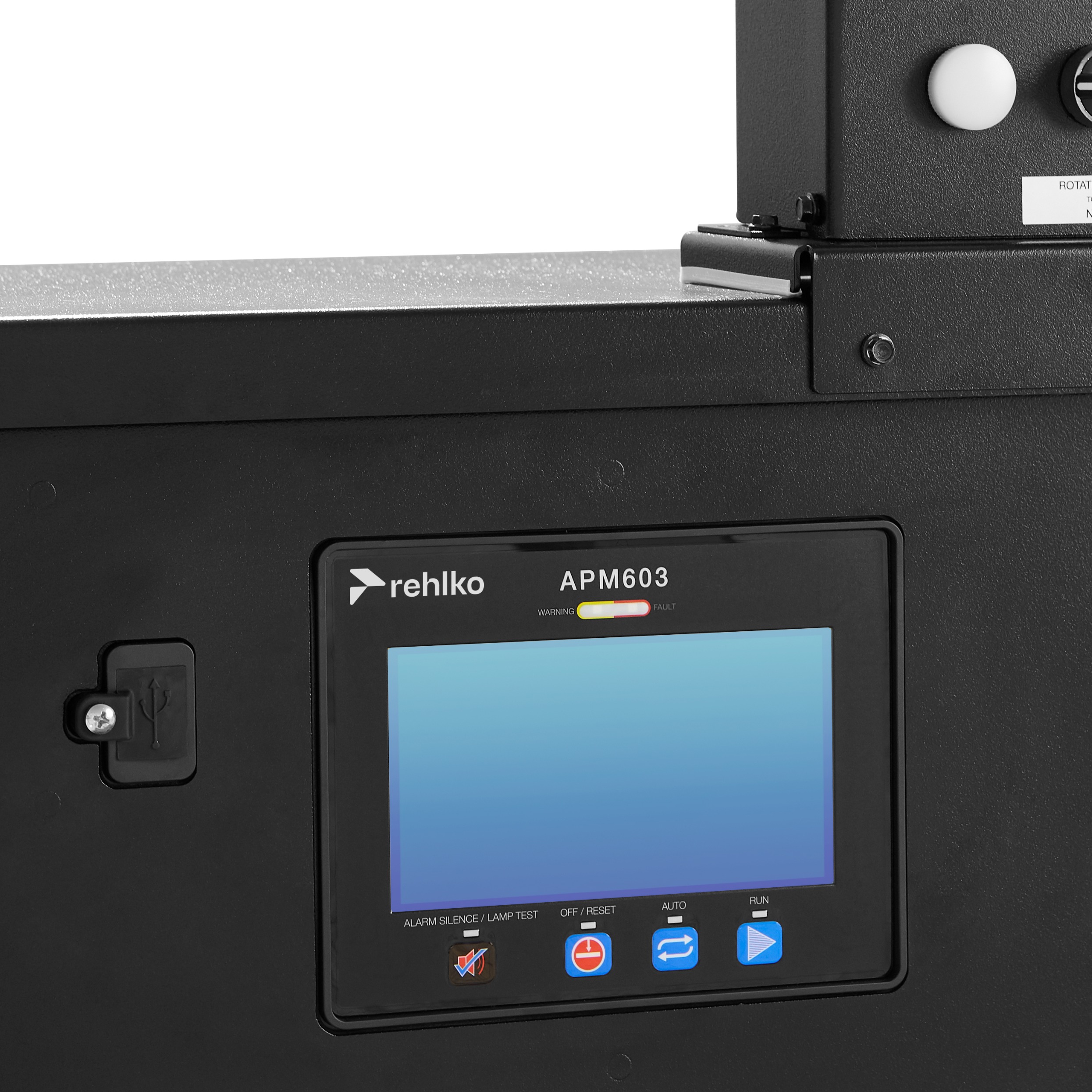 Close-up view of the APM603 controller panel, featuring labeled buttons and a display screen, with the Rehlko logo visible.