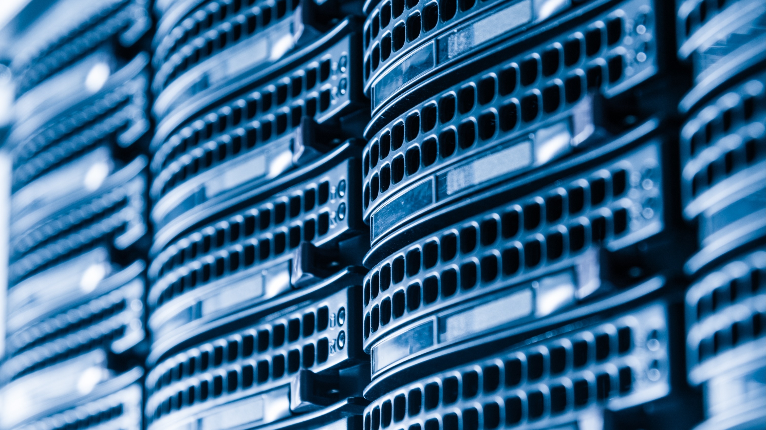 Close up image of servers in the slots of a data center rack enclosure.
