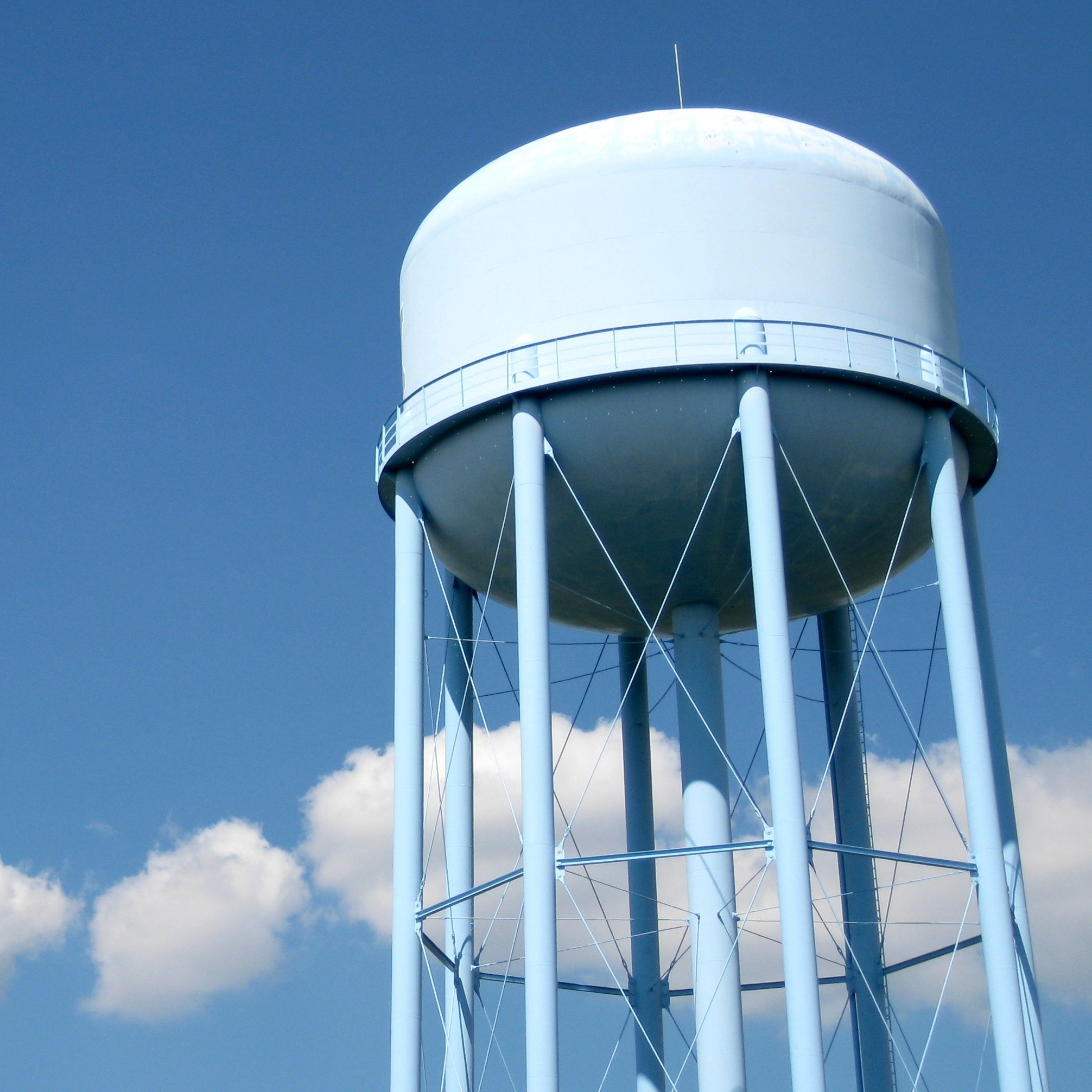 A water tower with a blue sky in the background.
