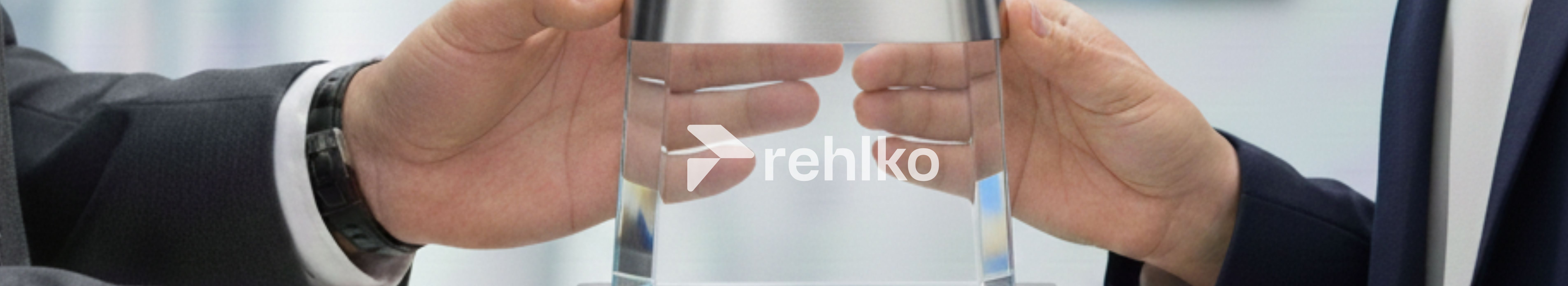 Hands holding the Rehlko award / trophy
