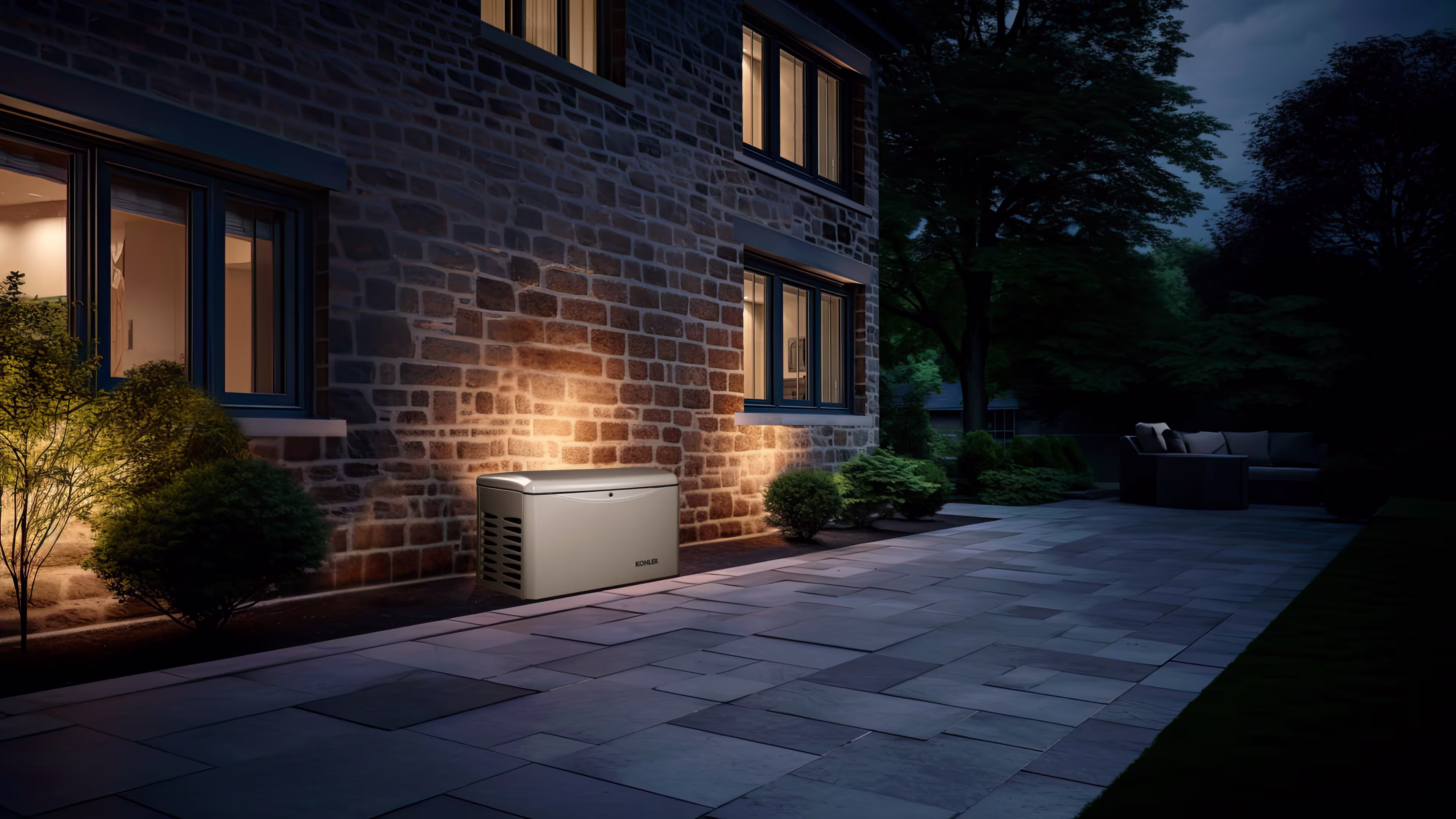 A portable generator positioned outdoors near a house, with a textured brick wall visible behind it, placed on a concrete or paved surface.