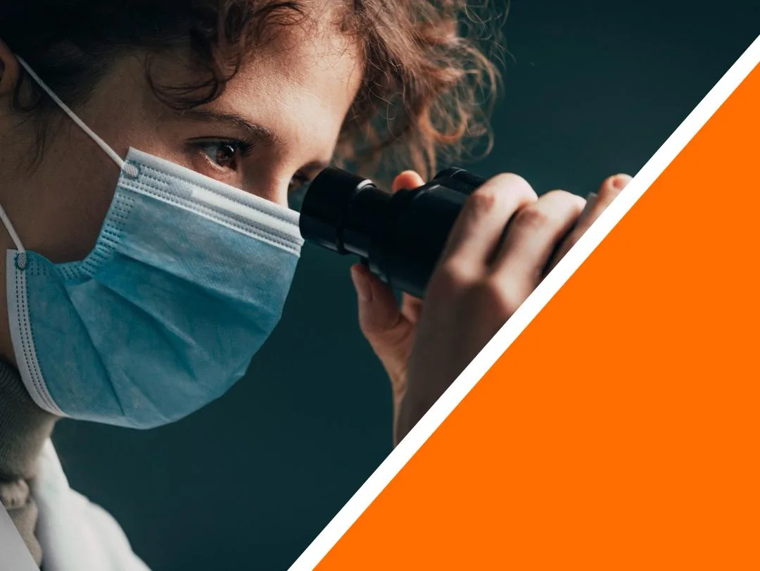 Close Up of a Medical Researcher Looking through a Microscope