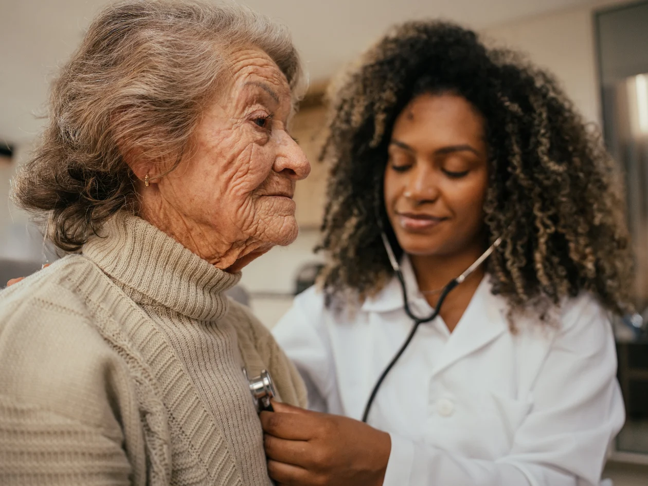 Female doctor checking a senior female patient 