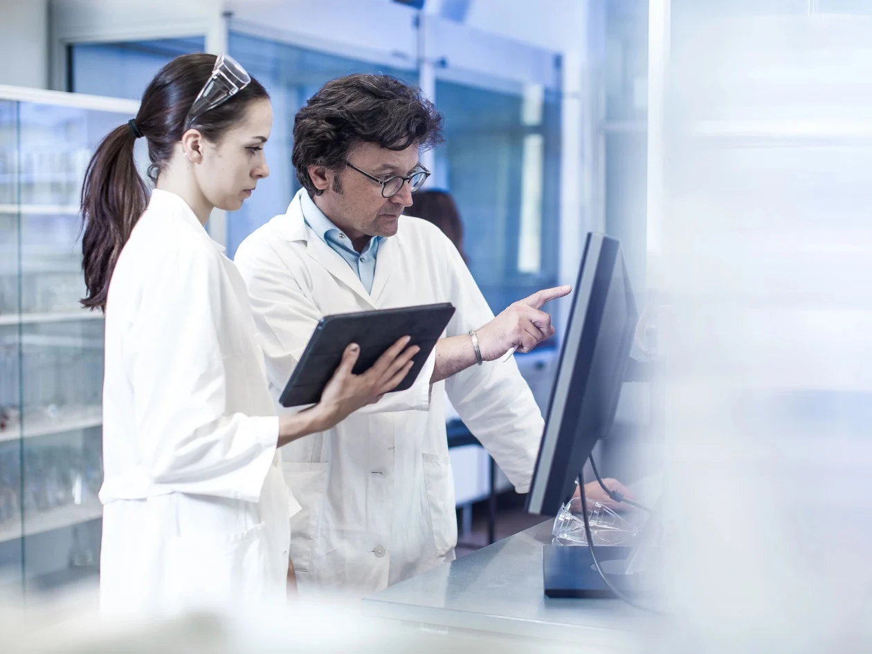 Chemists looking at a computer