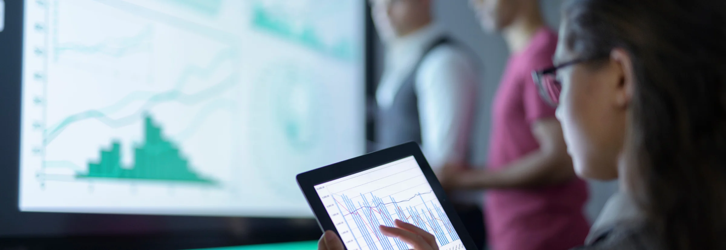 Business woman looking at a graph on a tablet 