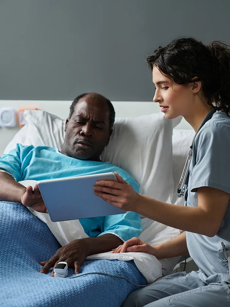 Nurse shows medical information to patient on a tablet