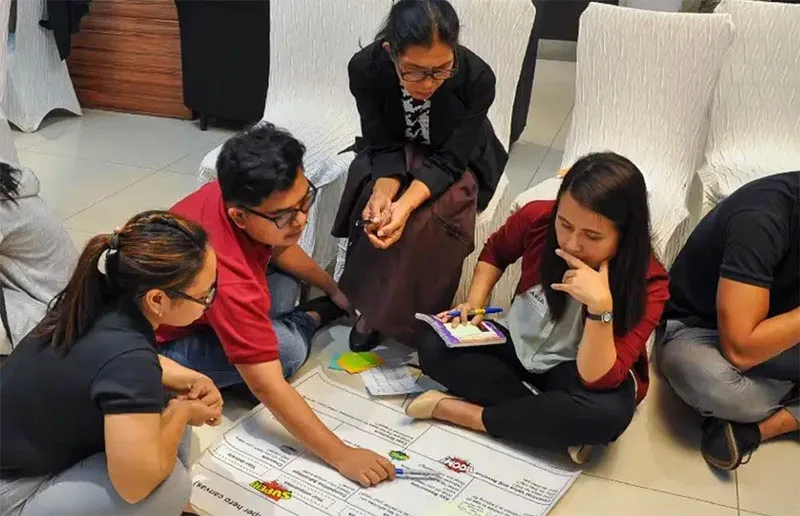 Dr Maria Wilvenna Añora (right) brainstorms with her team at AtoANI in the Philippines. 