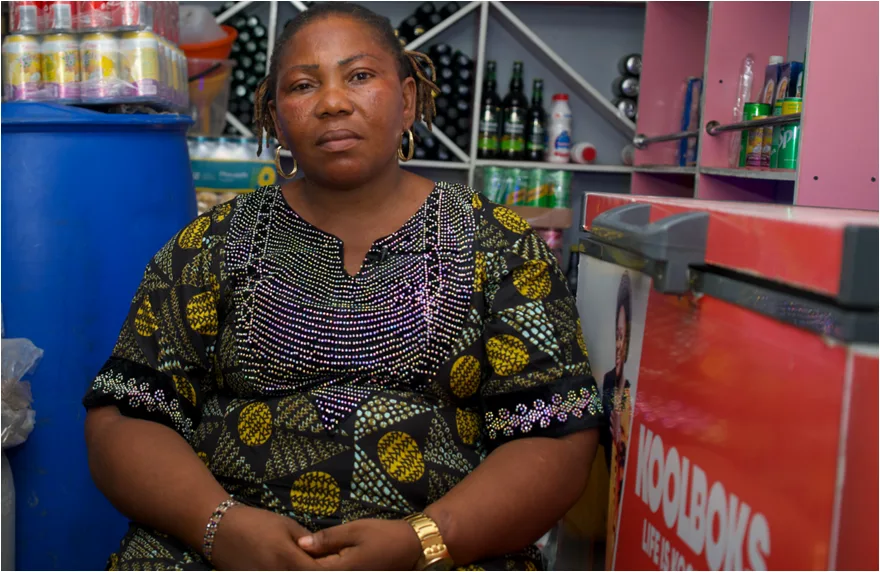 Doris Chuwa with the Koolbok solar refrigerator she bought for her small store in Nigeria.