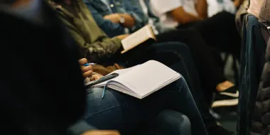 Meeting attendees taking notes