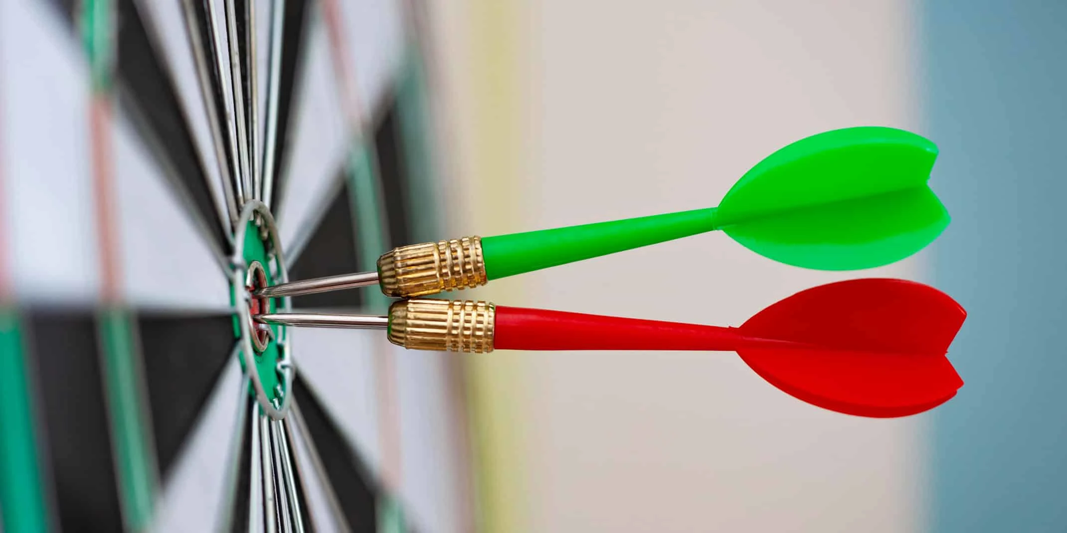 2 dart arrows in bulls eye on dart board