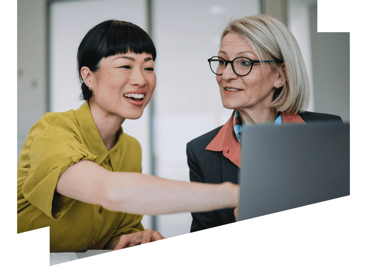 Two businesswoman looking at laptop 