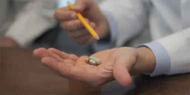 Co-author Ali Rezai, MD, holds the Celero VM Pill in his hand (Credit: WVU Rockefeller Neuroscience Institute)