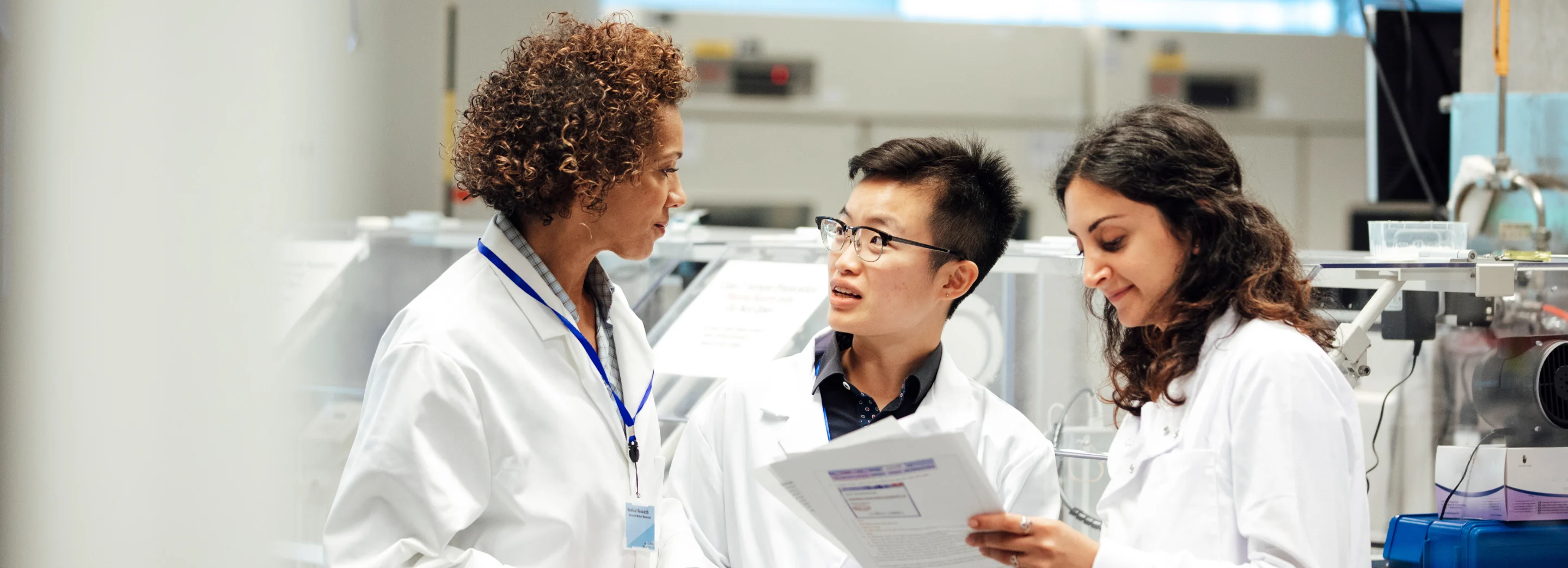 The research scientists discussing in lab